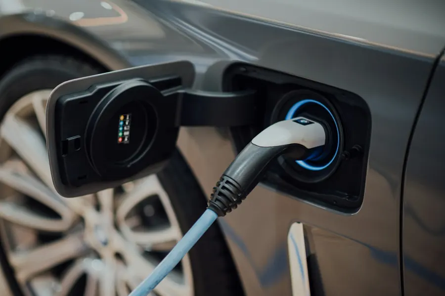 Electric vehicle charging cable connected to a car